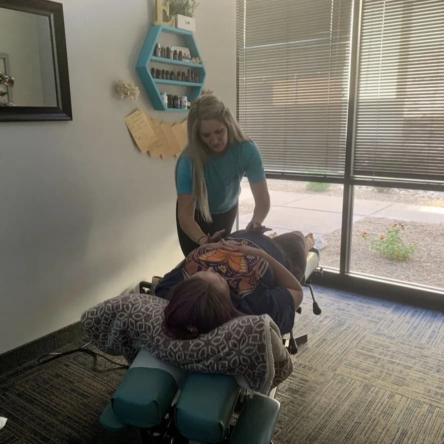 A pregnant patient receives adapted hands-on care at Complete Rehab QC.
