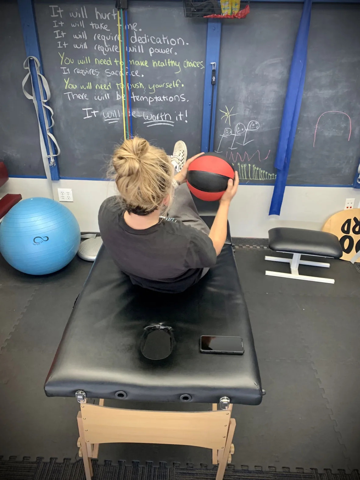 A clinician evaluates an athlete's movement at Complete Rehab QC.